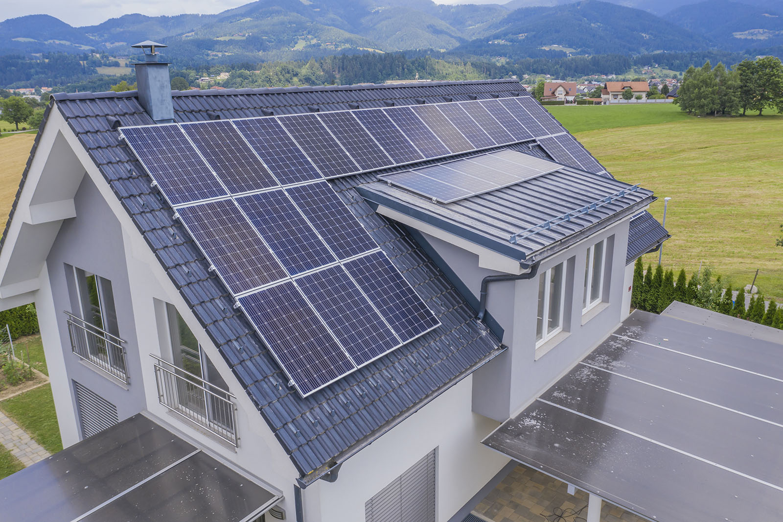 High angle shot of a private house situated in a valley with solar panels on the roof Solar Shingles