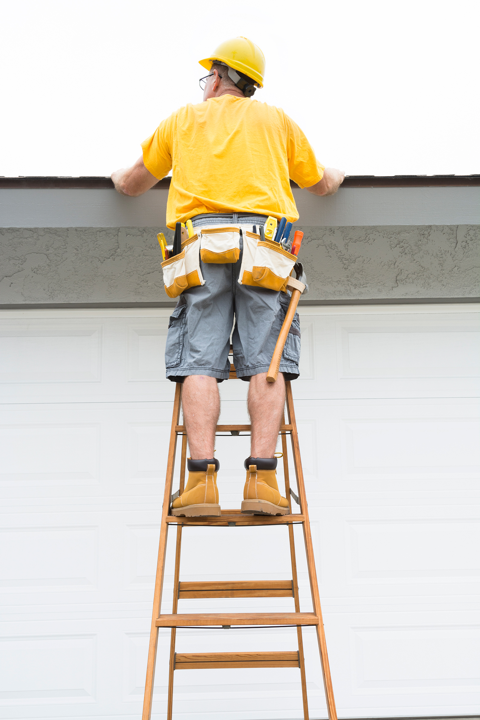 contractor-standing-on-ladder ROOF AND GUTTERS Free Inspection