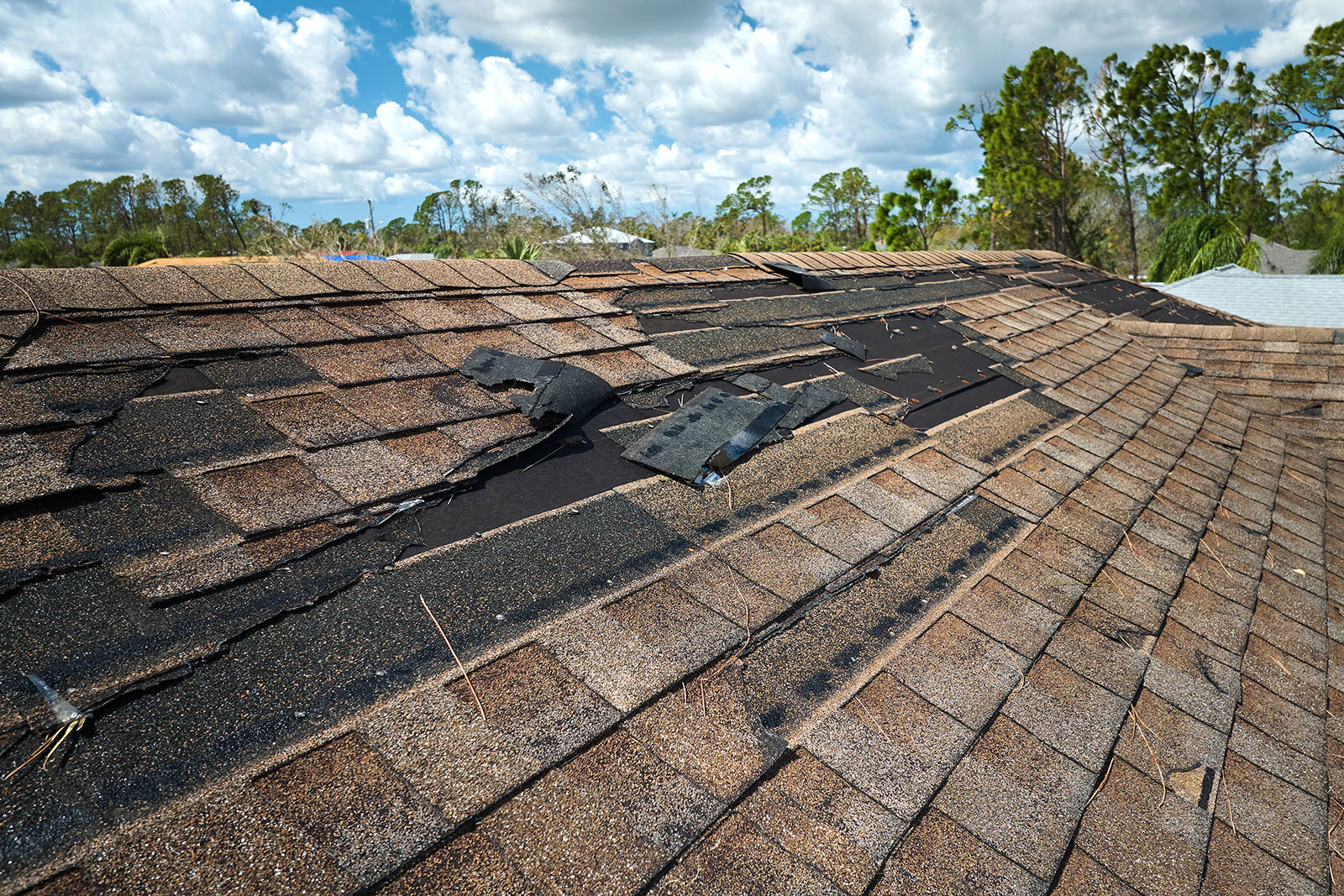 damaged-house-roof-with-missing-shingles-after-hur