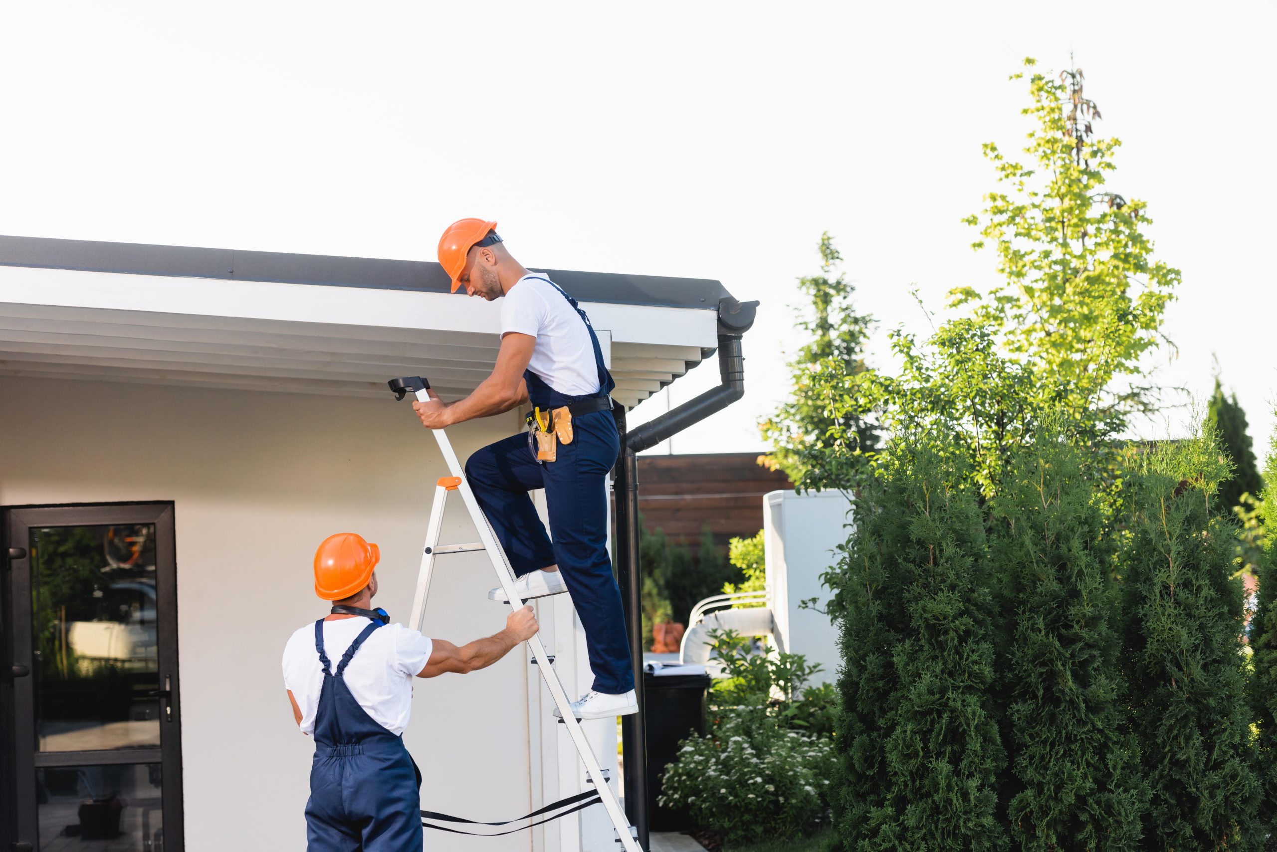 builders-using-ladder-near-facade-and-roof-of-buil-2023-01-30-22-56-47-utc-min Affordable Roof Repair Services in Colorado Springs