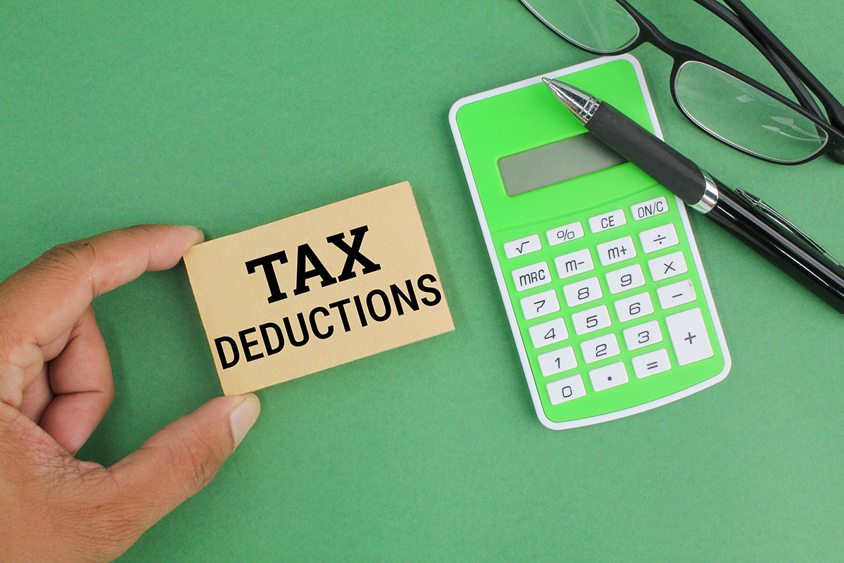 pen-calculator-glasses-and-paper-with-the-word-t-2023-03-15-08-33-38-utc Basic of Tax Deductions