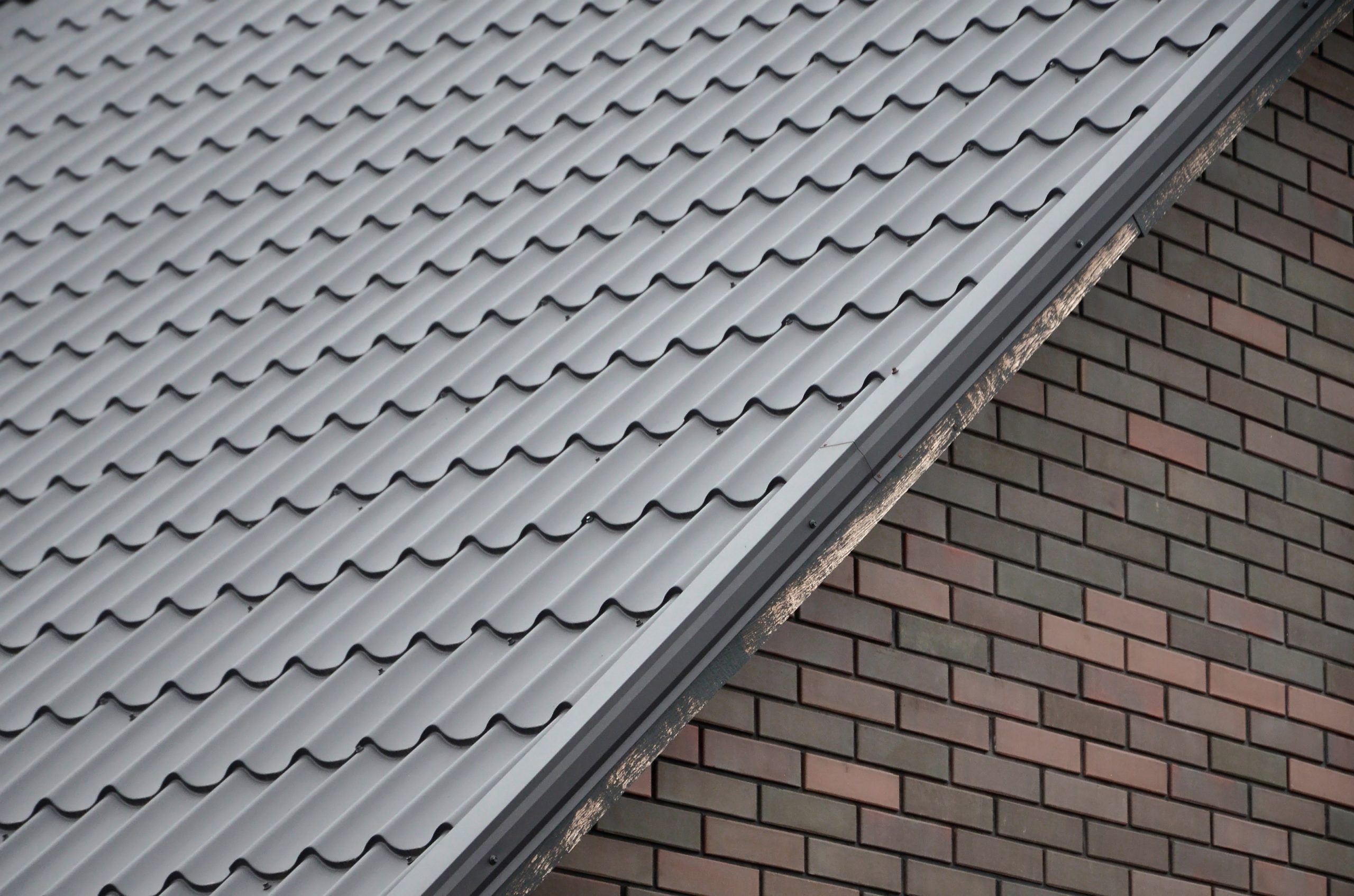 Modern brown roof made of metal. Corrugated metal roof and metal roofing industry concept Affordable Roof Repairs in San Antonio