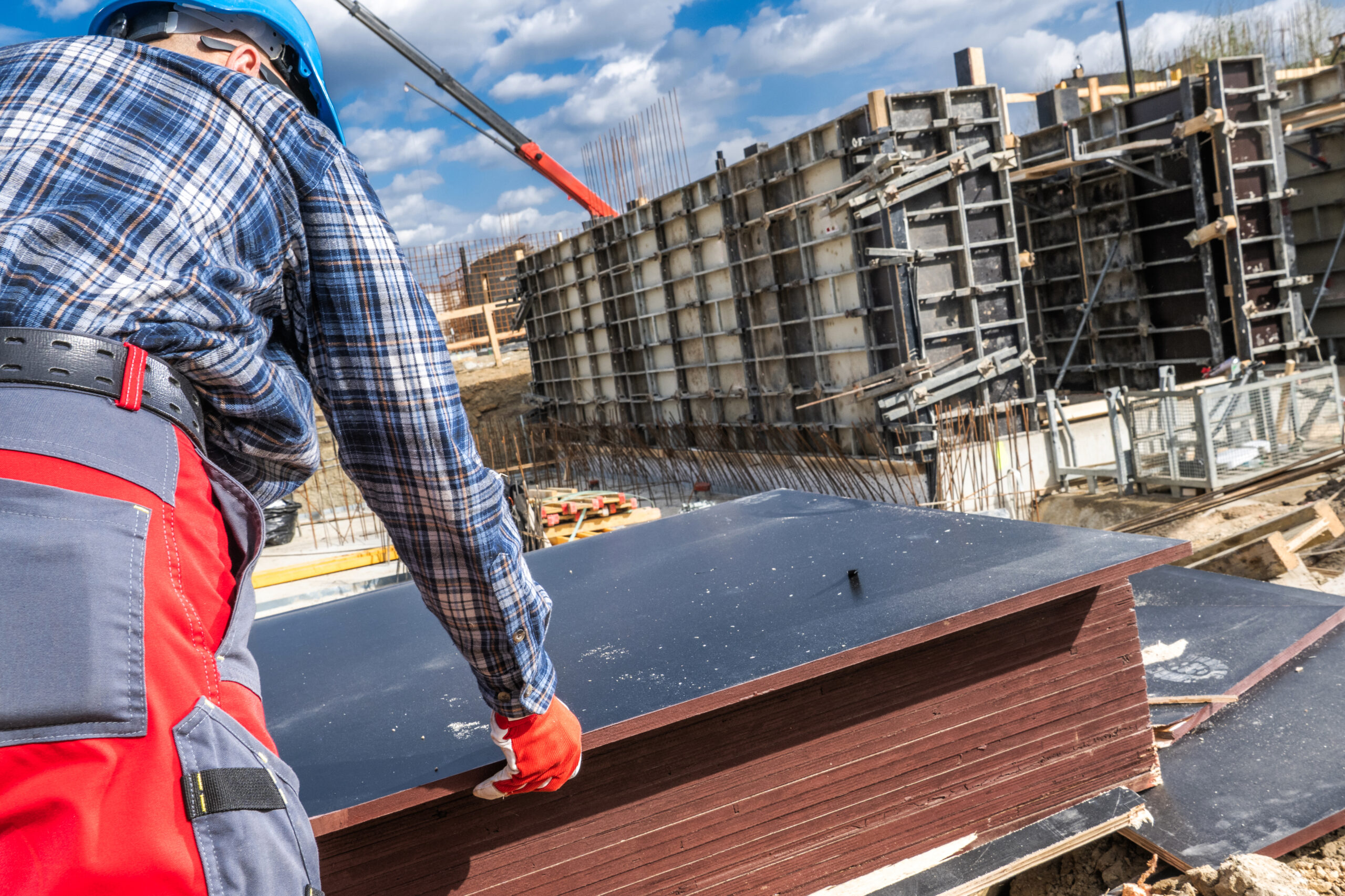 Construction Worker Handling Materials at a Building Site in Spring Commercial Roofing vs. Residential Roofing